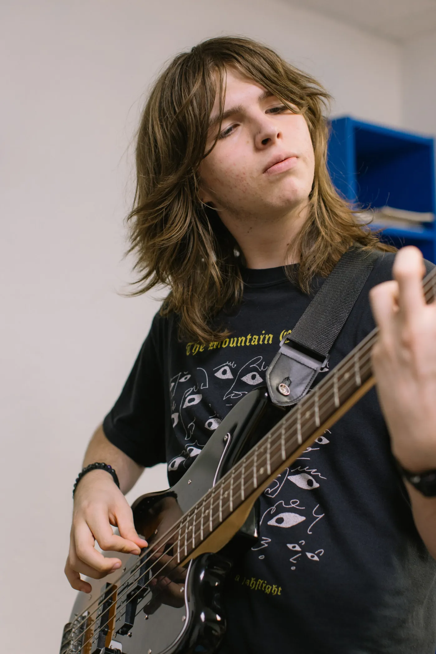 Teen student playing bass guitar during a lesson at LyriCo Conservatory