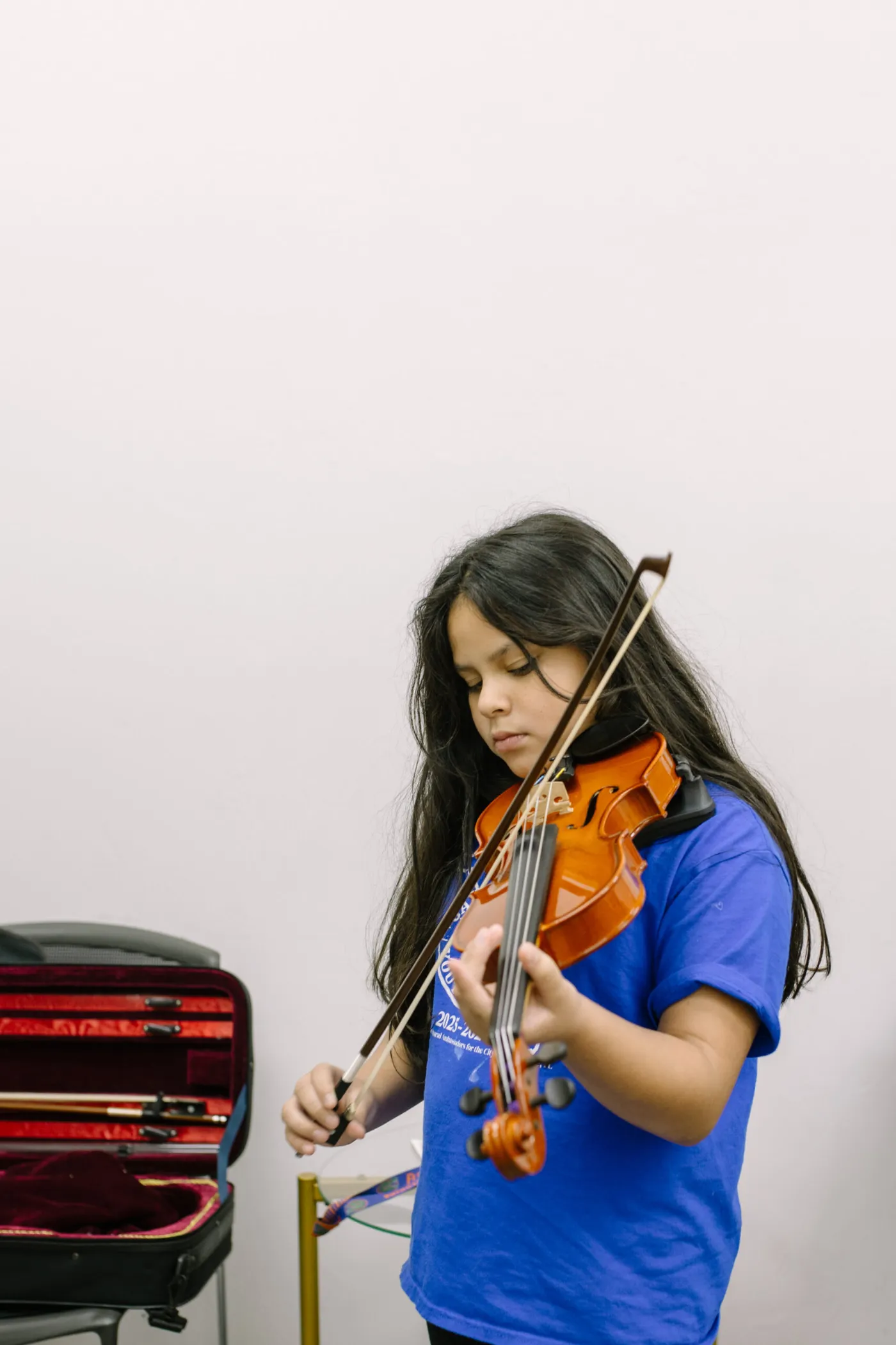 Young violin student playing during a lesson at LyriCo Conservatory in Gainesville